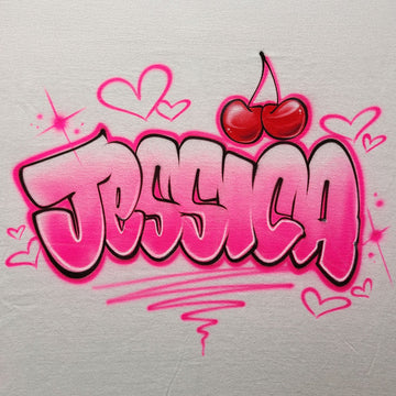 Custom airbrush shirt with bold pink bubble graffiti lettering, surrounded by hearts, sparkles, and topped with a red cherry design.