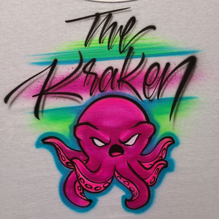 Custom airbrush shirt featuring a pink octopus character with graffiti-style tentacles, black script that reads “The Kraken,” and a neon blue and green spray background.