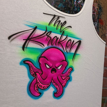 Custom airbrush shirt featuring a pink octopus character with graffiti-style tentacles, black script that reads “The Kraken,” and a neon blue and green spray background.
